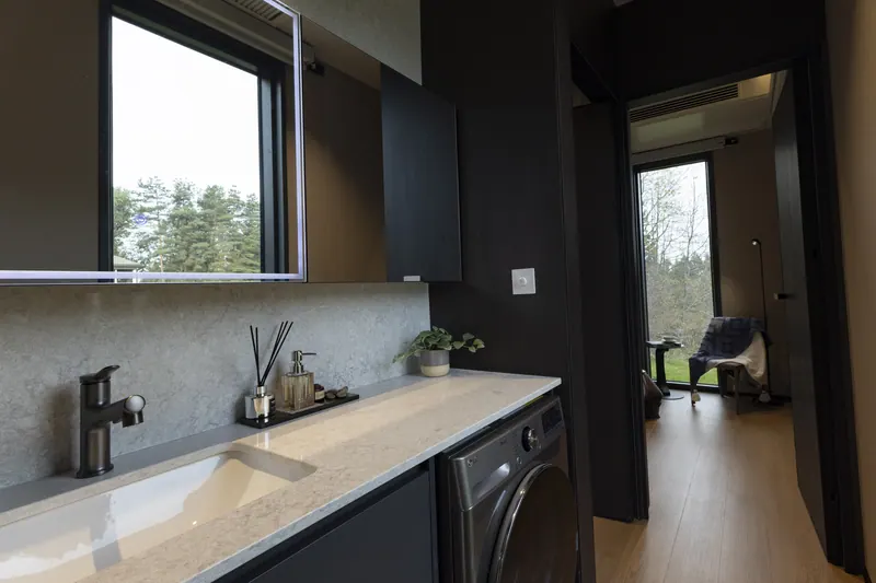 Ember kitchen counter in the dark finish with a washer beneath