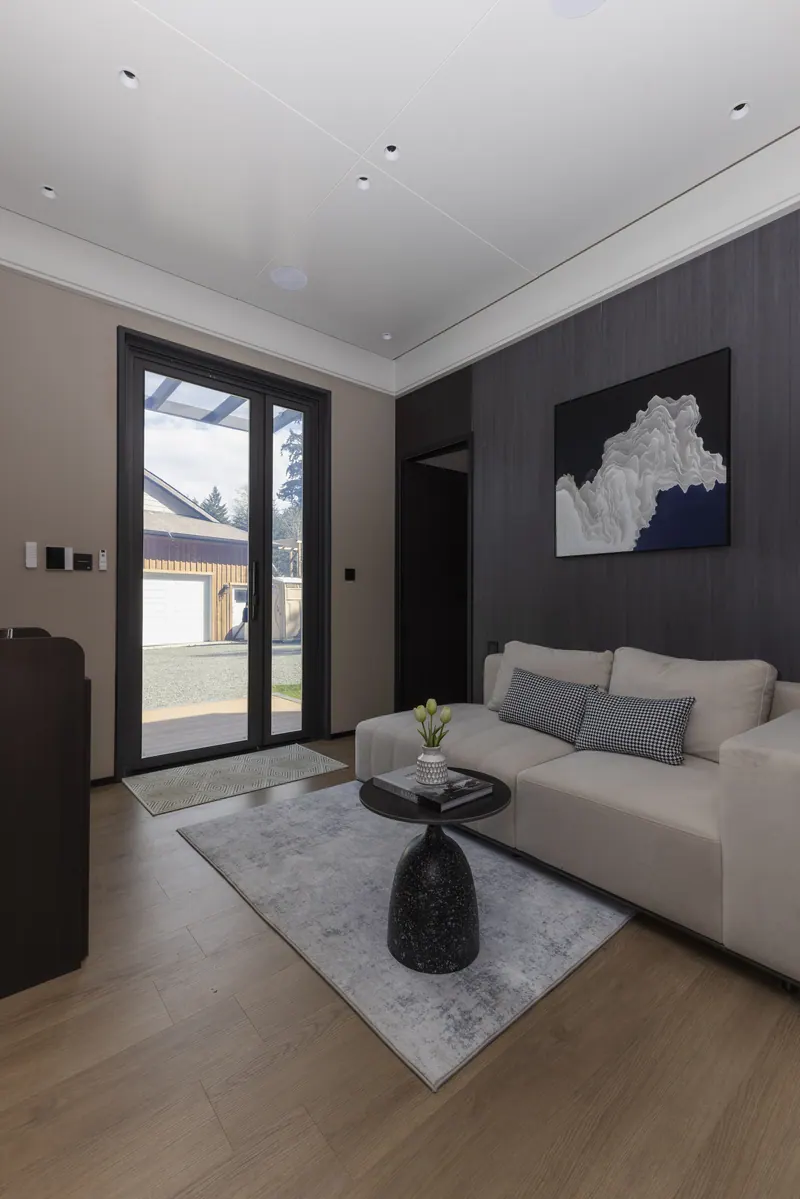 Ember living area with a gray sofa and dark feature wall