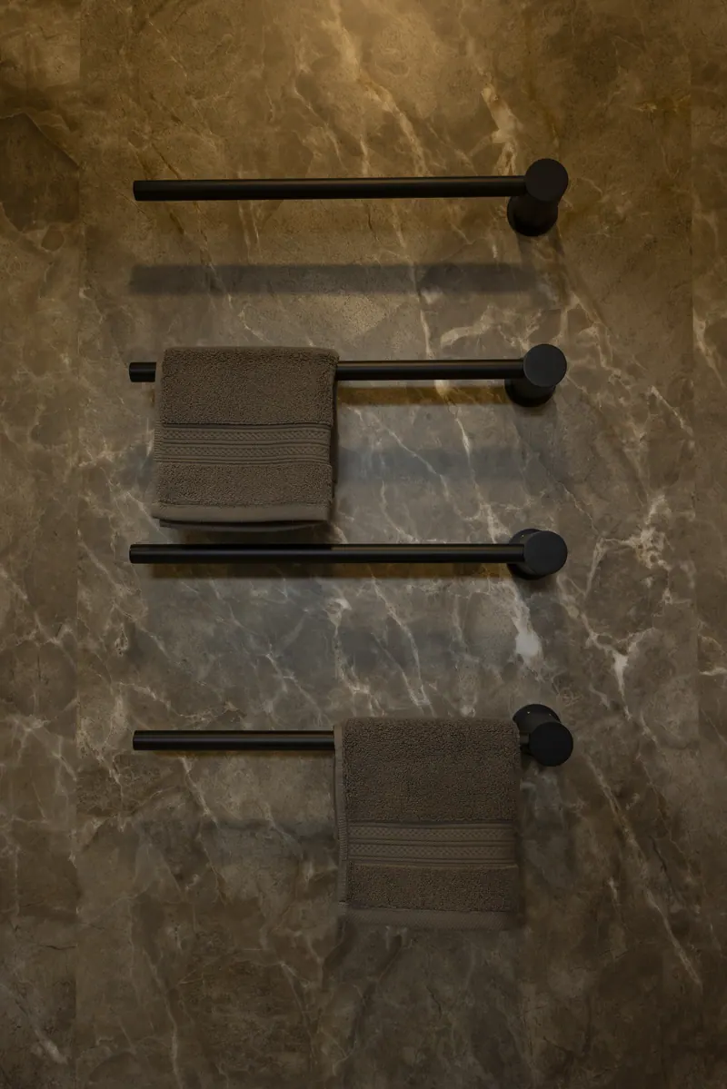 Heated towel rails on a stone-look wall