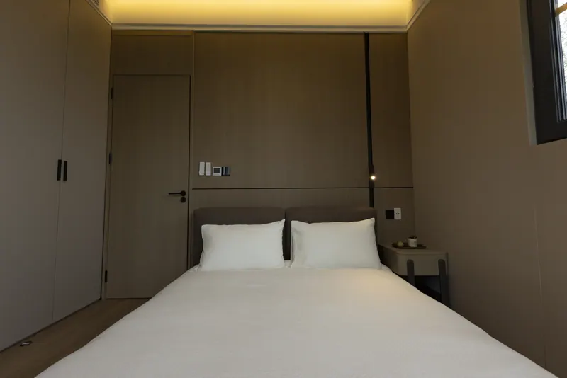 Solace bedroom with a white bed and cove lighting