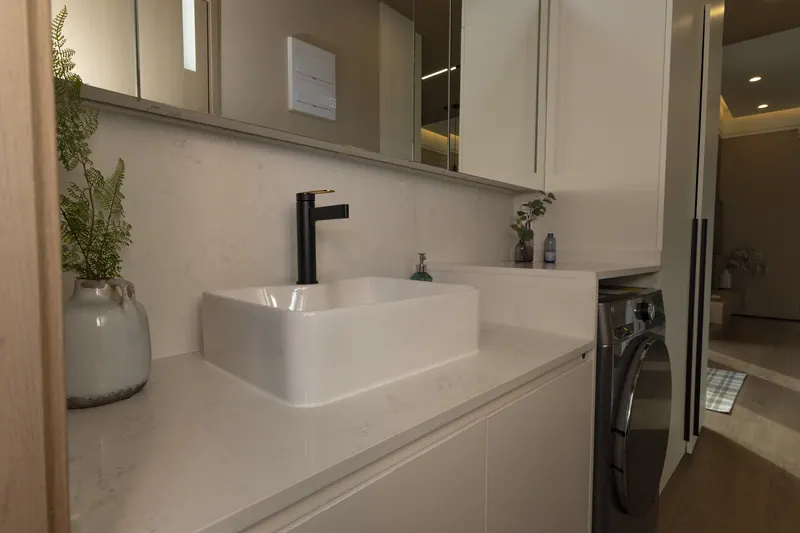 Bathroom vanity with a vessel sink and black faucet