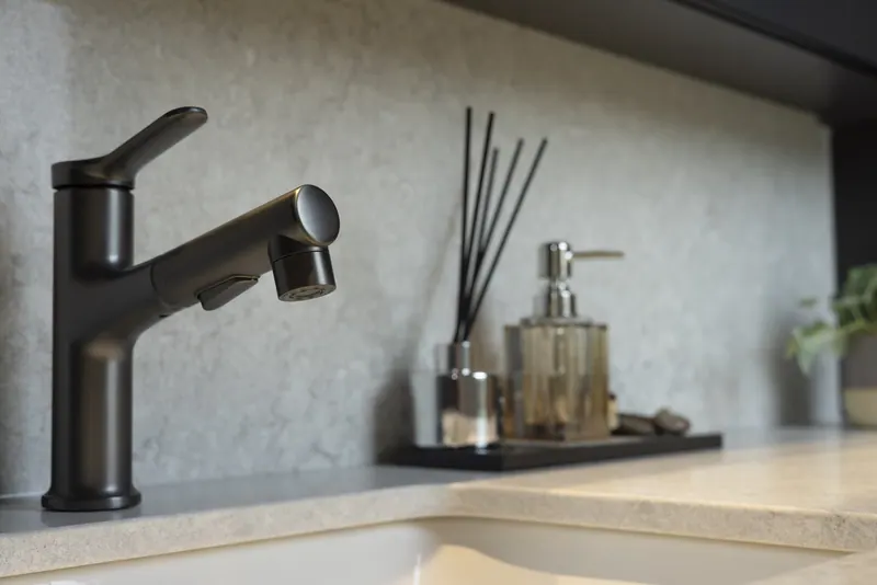 Matte black pull-out kitchen faucet on a quartz counter