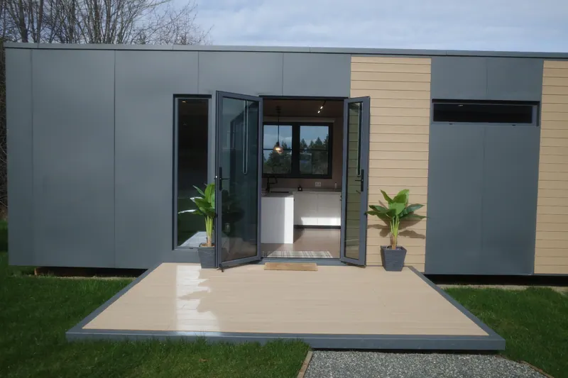 Show home with the front doors open, looking straight through to the kitchen window