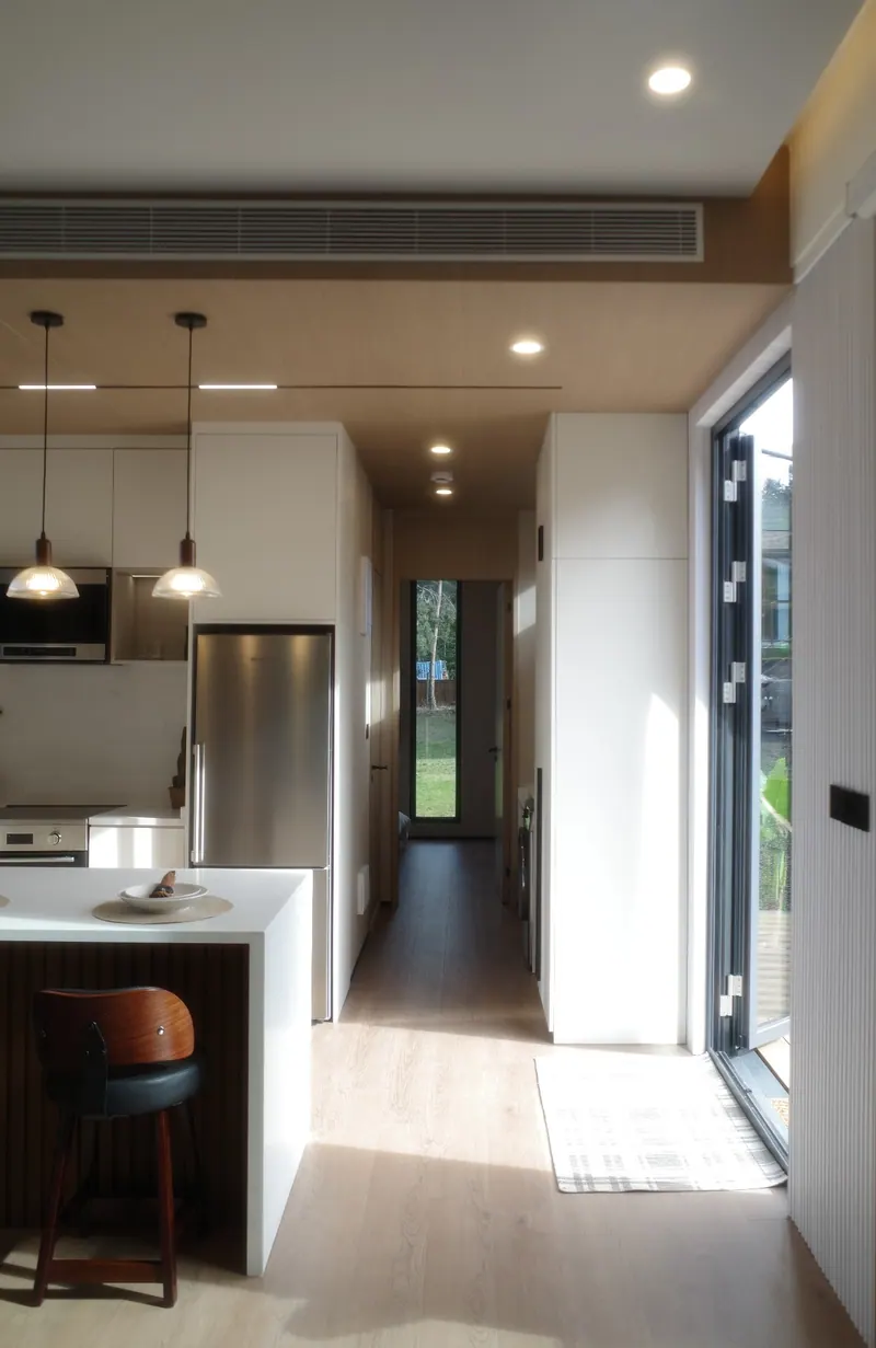 Full-length view through the home from the living area to the bedroom window