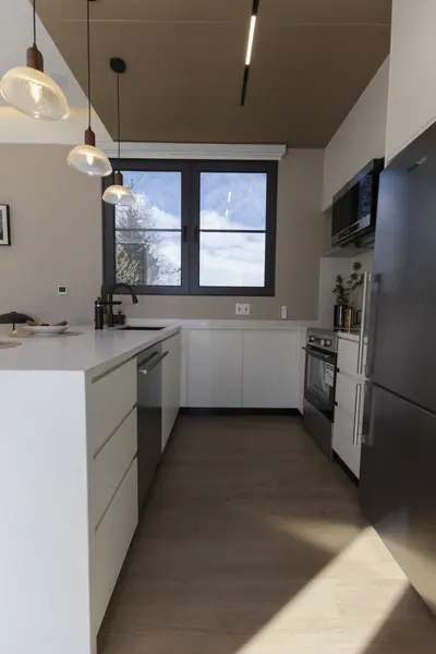 Kitchen with stainless fridge, range, microwave and dishwasher