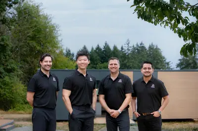 The Cueva team standing in front of a show home