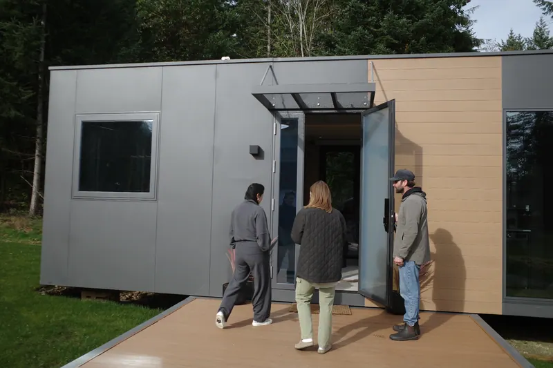 Three visitors walking up to the front door of a show home