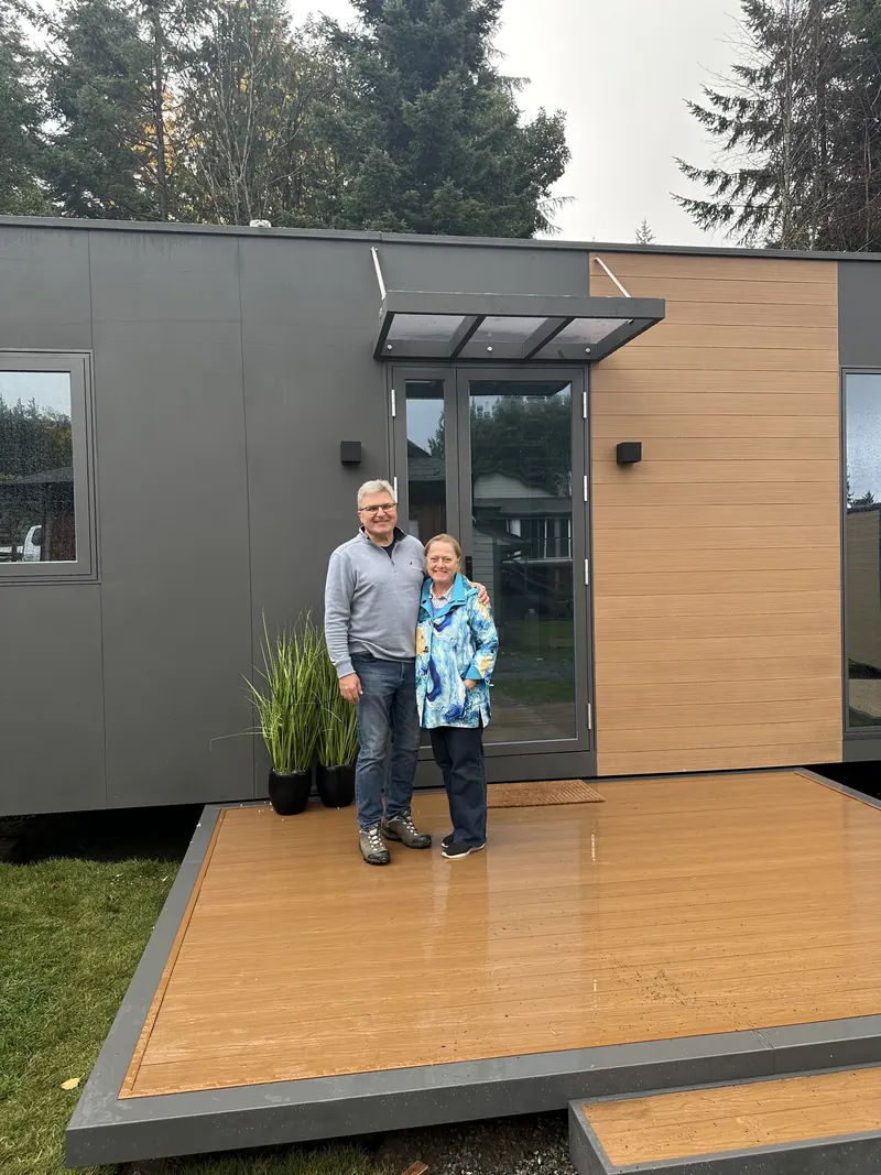 A couple standing on the deck of a show home