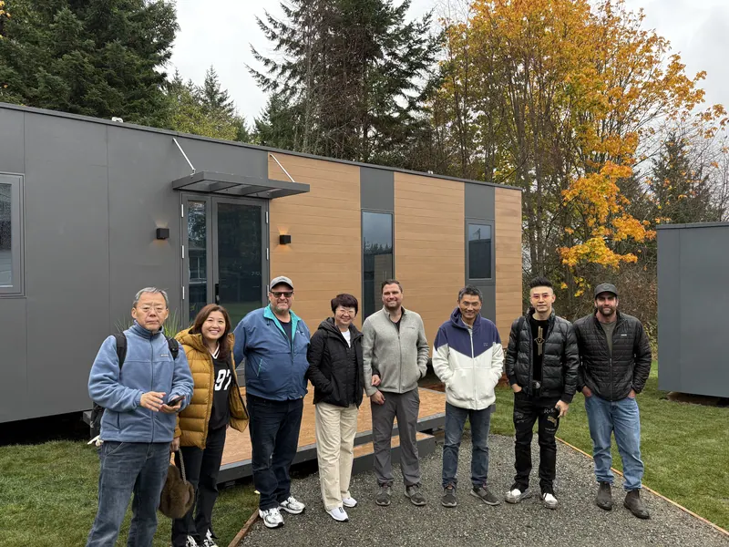 A group of visitors lined up outside the show homes in fall