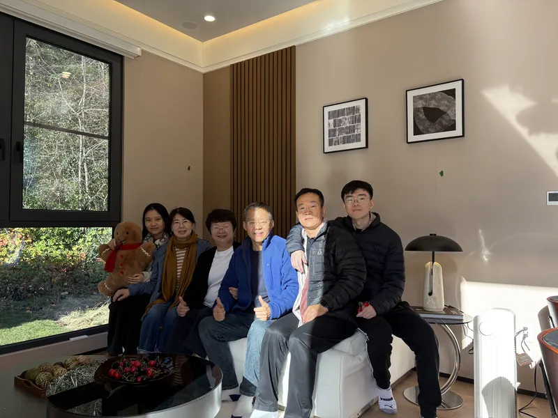 A group of visitors sitting together on the show-home sofa