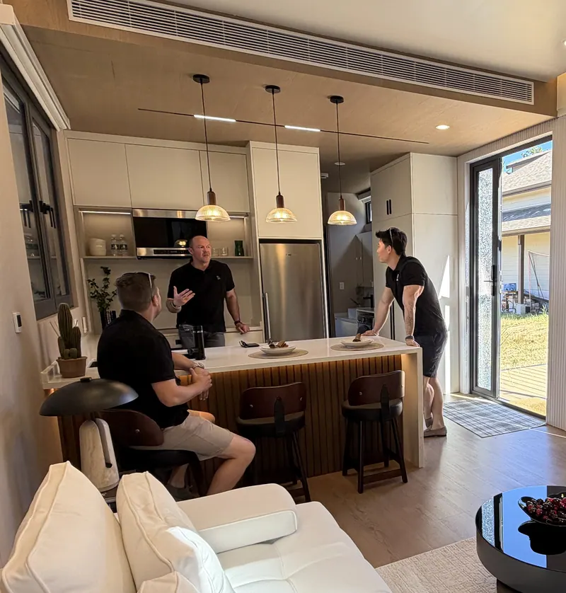 A visitor talking with a Cueva team member at the kitchen island