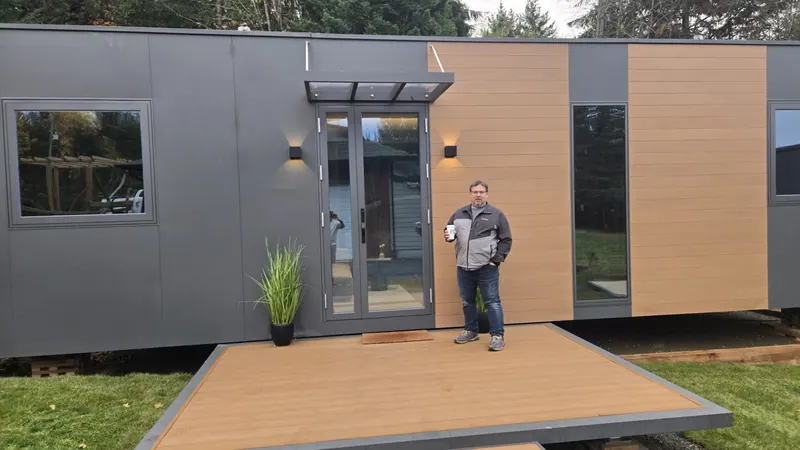 A visitor holding a coffee cup on the deck of a show home