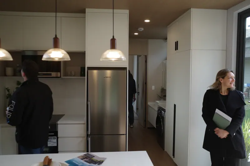 A visitor smiling in the show-home kitchen