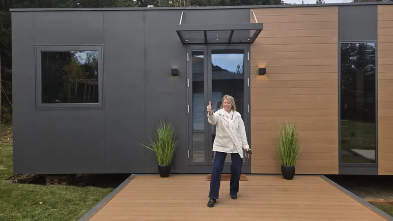 A visitor giving a thumbs-up on the deck of a show home